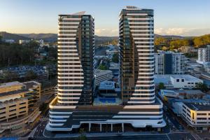 two tall skyscrapers in a city with buildings at voco Gosford by IHG in Gosford +90 photos