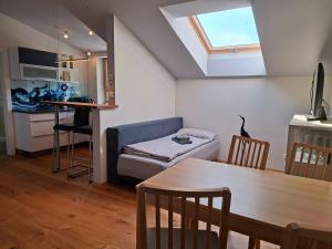 a small living room with a table and a couch at Apartment Niesenpoint in Albersdorf