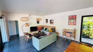a living room with a couch and a table at 6-person villa with pool in La Celle-sous-Gouzon