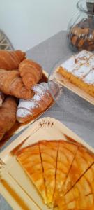 a table topped with different types of bread and pastries at Bed And Breakfast Le Azalee in Numana +19 photos