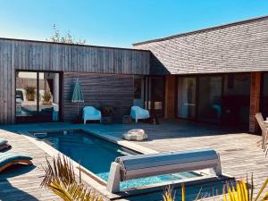 a house with a swimming pool and a deck at 6-person villa with pool in La Celle-sous-Gouzon