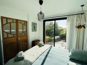 a bedroom with a bed and a large window at 6-person villa with pool in La Celle-sous-Gouzon +33 photos