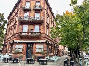 a building with tables and chairs in front of it at A different room in Frankfurt/Main