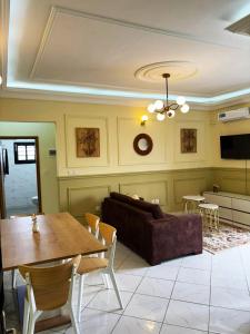 a living room with a couch and a table at Résidence Eden in Yaoundé