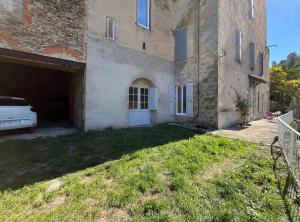 a car parked in a garage next to a building at Meublé Voltour dans la Villa Denise in Vals-les-Bains +27 photos