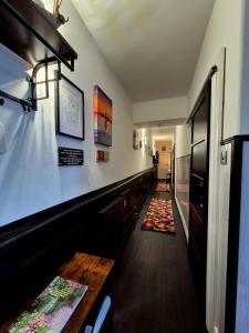 a long hallway with a bar with a table at Ta'Pinu House and Spa in Horse Isle +163 photos