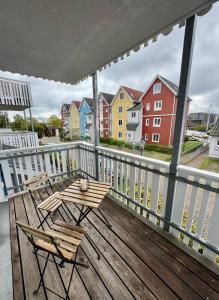 a balcony with chairs and a view of a town at Design City Apartment Casper am Yachthafen in Greifswald +7 photos