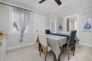 a kitchen and dining room with a table and chairs at Vintage West Central Apt Walkable Free Parking! in Fort Wayne