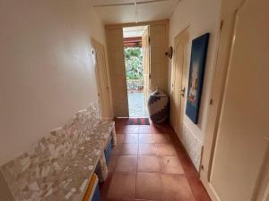a hallway with a stairway with a row of glasses at Casa Jujube - Guest House in Dakar