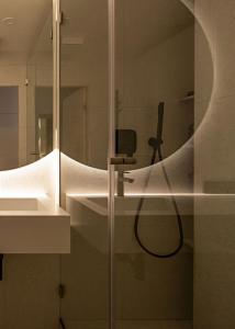 a bathroom with a shower with a mirror at Modern Home 