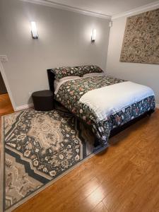 two beds in a room with a rug at Place near the Coquitlam River Park in Coquitlam