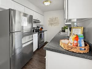 a kitchen with a stainless steel refrigerator and a counter at Gorgeous Clive Charmer, Near Shops, Trails & More! in Clive