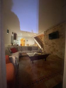 a living room with a couch and a table at Casa del Tío Marcelo in Pedraza-Segovia