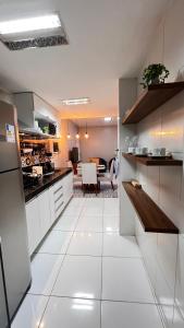 a kitchen with white tile floors and a dining room at Conforto & Estilo - Shows - Turismo - Negocios by Capta Stays in Belém