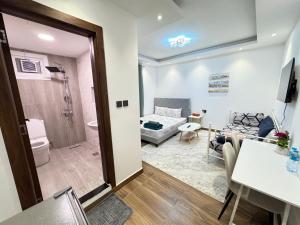 a room with a bathroom and a living room at Luxury Private Room near airport in Abu Dhabi