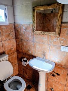 a bathroom with a toilet and a sink at Lavanda y Romero in Villa Yacanto