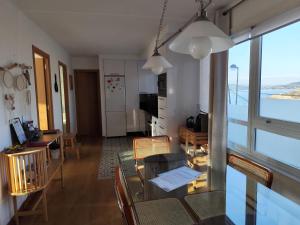 a living room with a table and chairs and a window at O Recuncho de Belén in Baiona