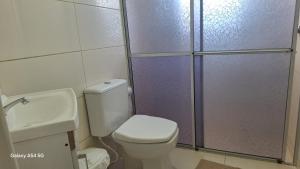 a bathroom with a shower and a toilet and a sink at Flat Harmonia in Harmonia +11 photos