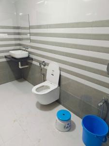 a bathroom with a toilet and a sink at Dholavira Desert Homestay in Dholovira