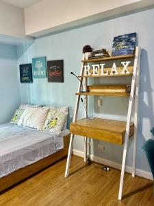 a bedroom with a bunk bed with a ladder and a desk at Bleu Suite in Abreeza Place Davao City in Sampong