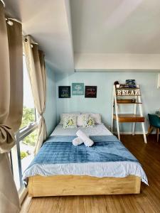 a bedroom with a bed in a room with a ladder at Bleu Suite in Abreeza Place Davao City in Sampong