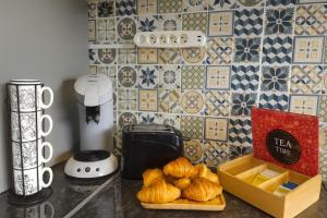 a kitchen counter with a box of croissants on it at La longère des cerisiers 