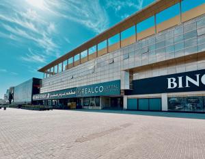 a large building with a brick road in front of it at Signature Vista Studio Apartment in Dubai