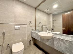 a bathroom with a sink and a toilet at Signature Vista Studio Apartment in Dubai +6 photos