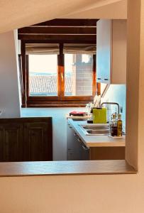 a kitchen with a sink and a window at Suite Cascina Balocco in Neive