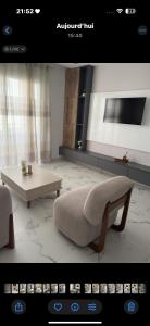 a rendering of a living room with a couch and a table at Apartement luminéo hammamet nord in Hammamet