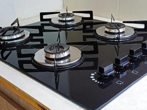a stove top with four pots and pans on it at Departamento Oberá-1 in Oberá