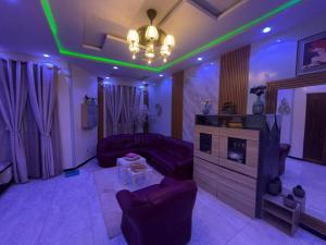 a living room with purple and green lights at Twi M Résidence in Thies