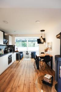 a kitchen and living room with a table and a dining room at NEU, Berg Nest, mit Aussicht im Harz & großzügigen Garten in Walkenried