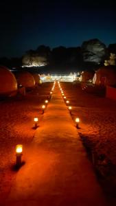 a row of candles on a beach at night at The Celestial Dome in Disah