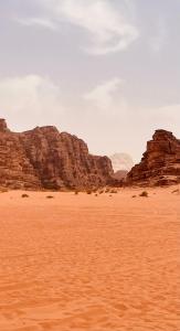a desert with some rocks in the background at The Celestial Dome in Disah