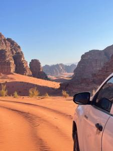 a car parked on a dirt road in the desert at The Celestial Dome in Disah +2 photos