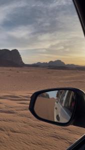 a rear view mirror of a car in the desert at The Celestial Dome in Disah