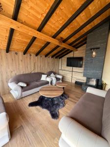 a living room with a couch and a table at Paradiso View Villa in Popova Shapka