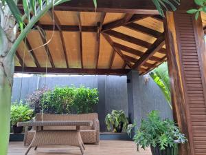 une pergola en bois avec un banc sur une terrasse dans l'établissement WahikaStay, à Masindi