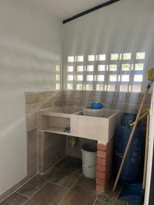 a kitchen with a sink in a room at Alojamiento Rural Cafetero, Andinapolis, Trujillo  +8 photos