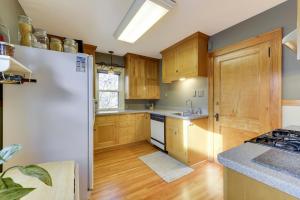 a kitchen with wooden cabinets and a white refrigerator at Minneapolis - Blaisdell Avenue in Minneapolis