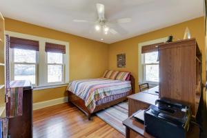 a bedroom with a bed and two windows at Minneapolis - Blaisdell Avenue in Minneapolis