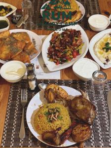 a table with plates of food on it at Rum Luxury Camp in Wadi Rum