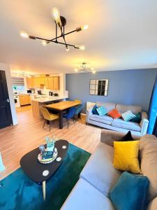 a living room with a couch and a table at Stylish Townhouse in Rugby, sleeps up to 9! in Rugby