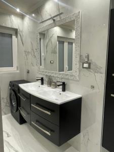a bathroom with a sink and a mirror at airport apartments camera narciso in San Maurizio Canavese +20 photos