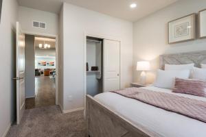 a bedroom with a large bed and a hallway at Luxury 5 BR Oasis Movie Room Fenced Yard in Albuquerque