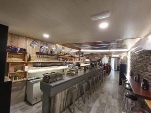 a restaurant with a bar with stools at Kilómetro99 in Lugo