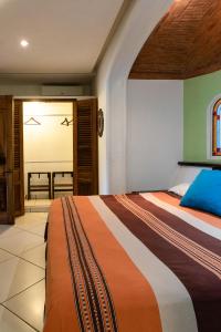 a bedroom with a large bed and a large window at Say-olita in Sayulita