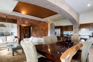 a kitchen and living room with a wooden table and chairs at Say-olita in Sayulita