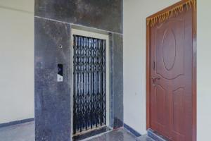 a red door in a room next to a wall at Hotel O Sri Residency in Hyderabad